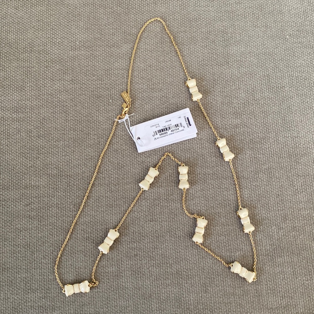 Cream “Take a Bow” Kate Spade necklace.